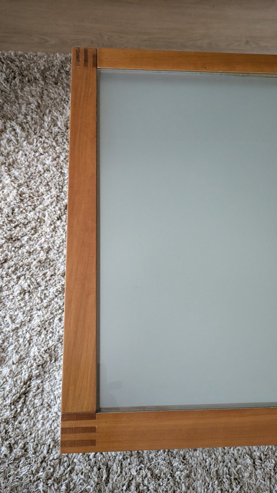 Image 1 of cherry wood red coffee table with sleek glass top from 1996