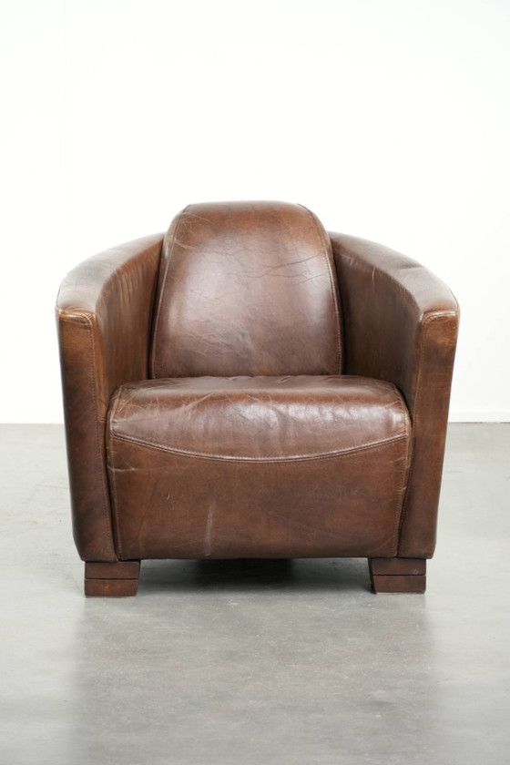 Image 1 of Karaktervolle en stoere donker cognac bruine rundleren Aviator design fauteuil/ armchair met een interessante vorm