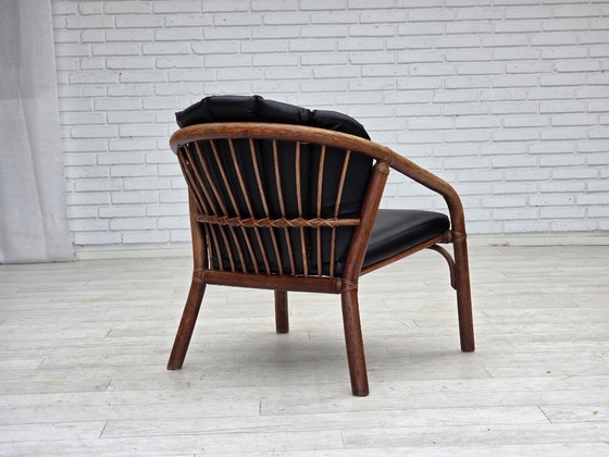 Image 1 of 1970s, Danish armchair, rattan, black artificial leather.