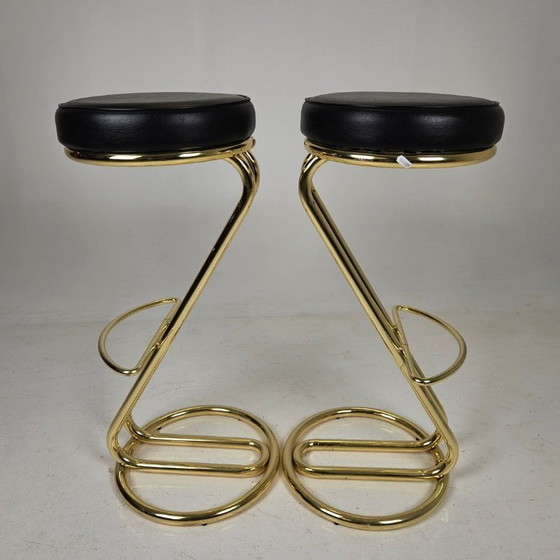 Image 1 of two bar stools, distinguished by their clean lines, high-quality craftsmanship, and timeless elegance.