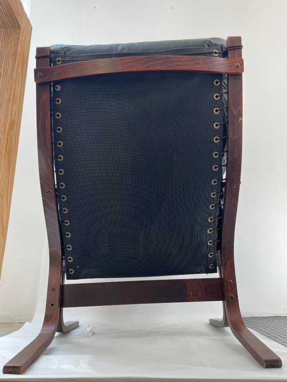 Image 1 of Siesta armchair and footrest in black leather and mahogany wood