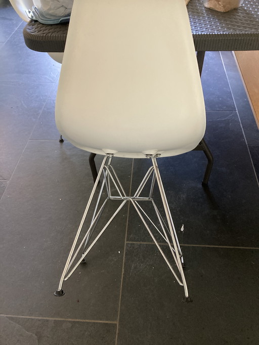 2 white Eames chairs