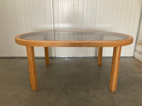 Image 1 of Table de salle à manger ovale en rotin et bambou avec plateau en verre fumé, 1970
