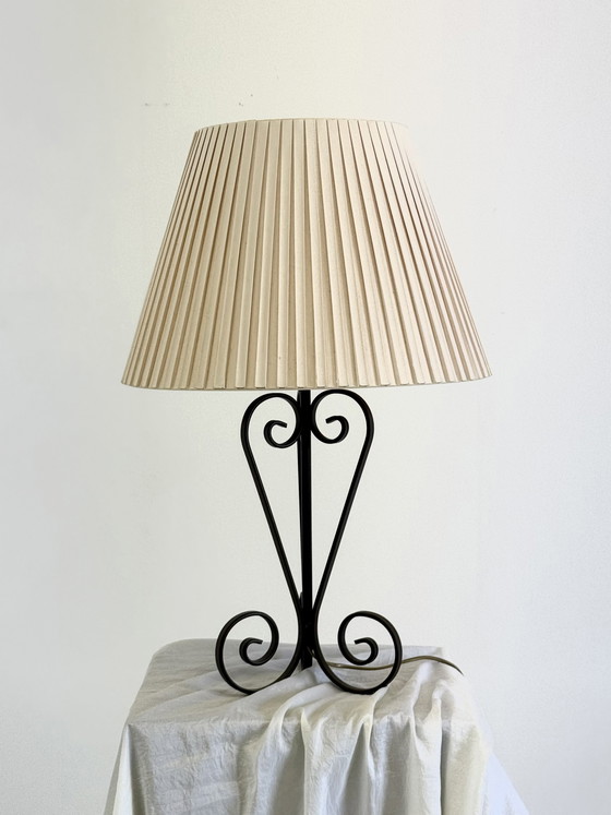 Image 1 of Vintage wrought iron table lamp in a swirl shape with a pleated shade