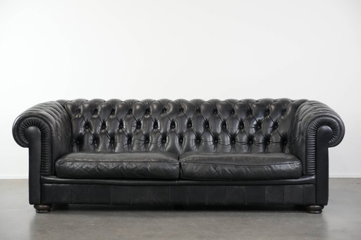 Set consisting of a black Chesterfield sofa, armchair and footstool made of cowhide