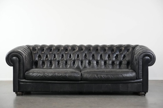 Image 1 of Set consisting of a black Chesterfield sofa, armchair and footstool made of cowhide