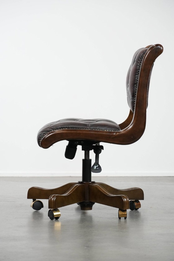 Image 1 of English-style Chesterfield office chair made of cowhide and wood on wheels