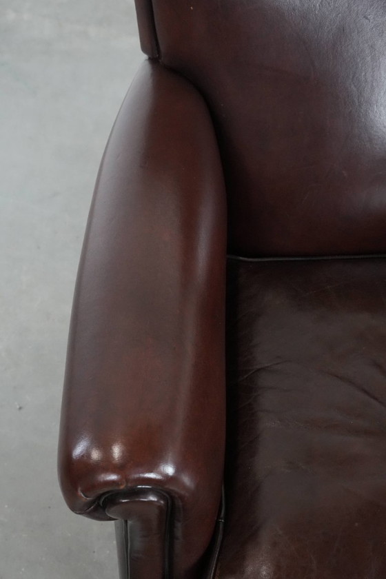 Image 1 of Donkere luxe schapenleren fauteuil/ armchair met een tijdloze uitstraling