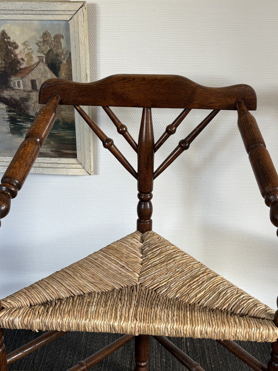 Image 1 of  Vintage Antiek 20ste eeuw eiken hoekstoel met biezen zitting h85cm