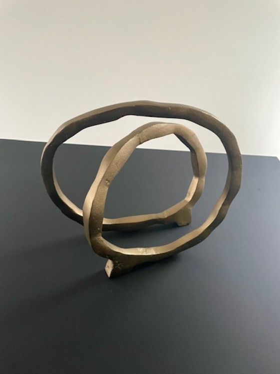 Image 1 of Escultura de diseño con forma de anillo abierto en oro mate.
