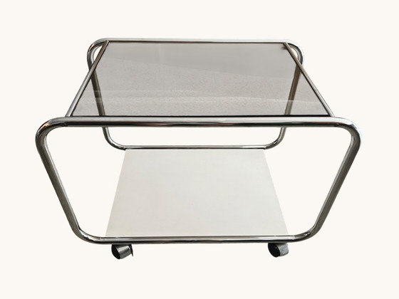 Image 1 of Vintage Space Age side table made of chrome and smoked glass. Sculptural 70s design with wheels.