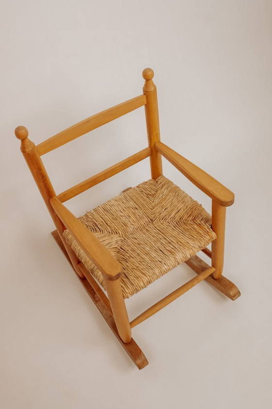 Image 1 of Vintage wooden children's rocking chair with rush seat