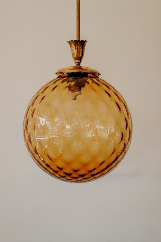 Brass Pendant Lamp with Round Orange Glass Shade and Swirl Structure (photo 8 of 8)
