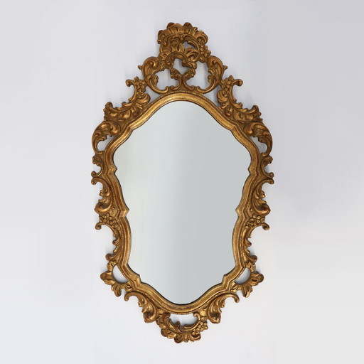Baroque style oval wall mirror in gilded wood, France