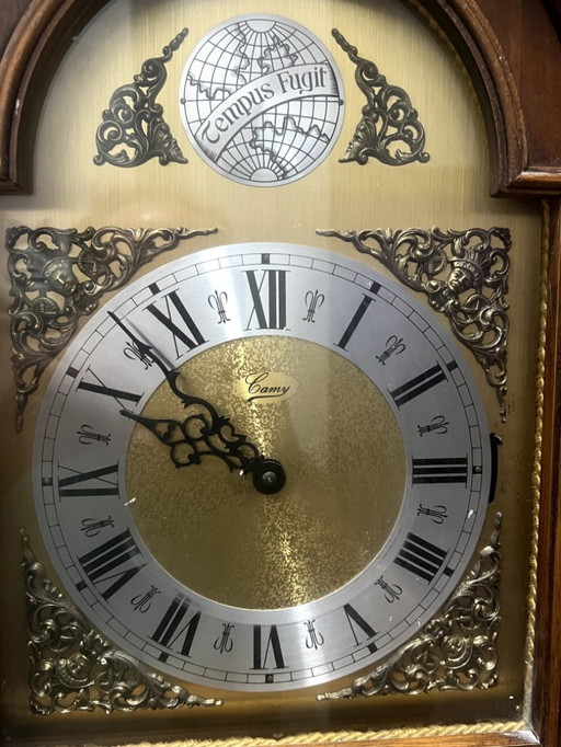A wooden pendulum clock with a Swiss mechanical movement