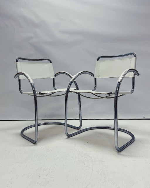 Vintage tubular frame chairs with white skai