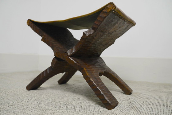 Image 1 of Brutalist Folding Stool Leather Sling Seat Hand Carved Wood X Frame 1950s Rustic Mid Century Ottoman