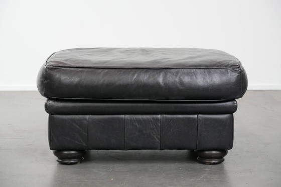 Image 1 of Set consisting of a black Chesterfield sofa, armchair and footstool made of cowhide