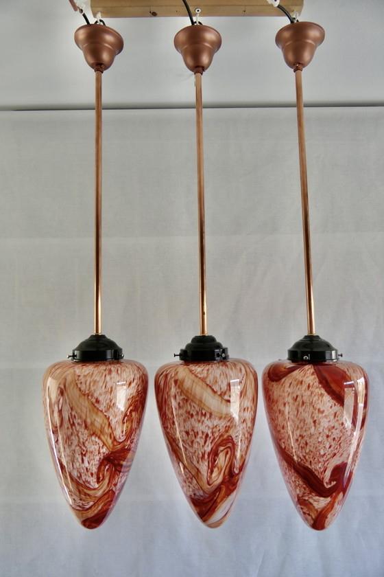 Image 1 of Drie Sfeervolle Druppelvormige Hanglampen van Rood Gemarmerd Opaline Glas