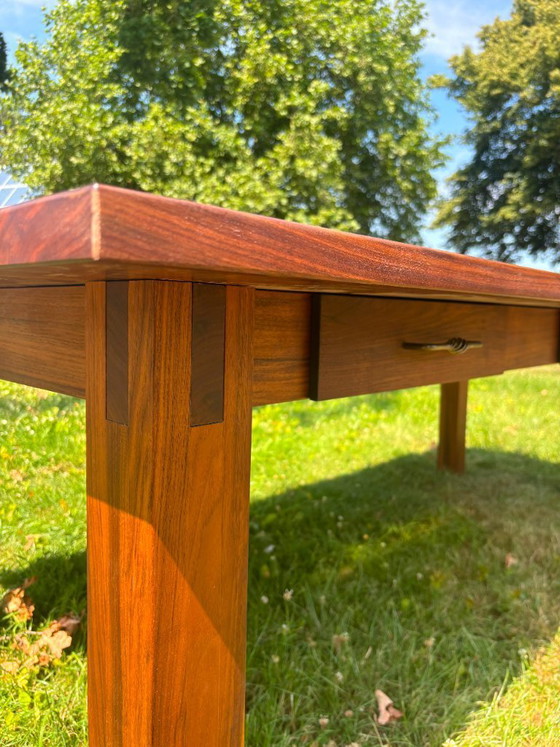 Image 1 of Dining table in American walnut and maple. Handcrafted solid wood extensions and drawers. Live edge for visual depth. Epoxy resi