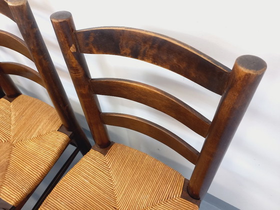 Image 1 of Set van 6 vintage brutalistische stoelen van Georges Robert, gemaakt van hout en stro, uit de jaren 50 en 60.