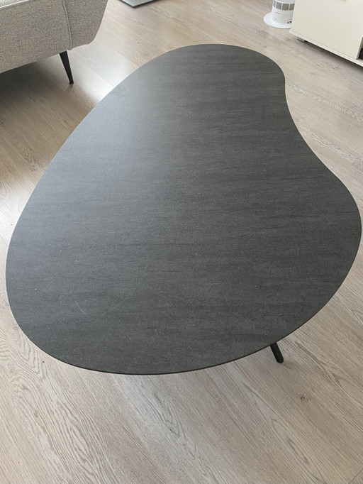 Hulshoff coffee table. Ceramic top with three metal legs. Kidney-shaped. Dimensions 76x120cm. As good as new.