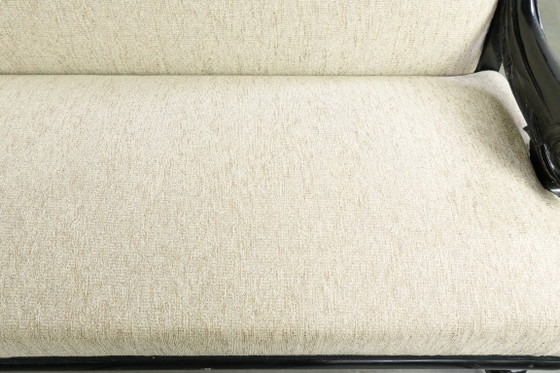 Luxurious 19th-century French sofa in Empire style with cream-colored fabric and uniquely detailed armrests. (photo 6 of 13)