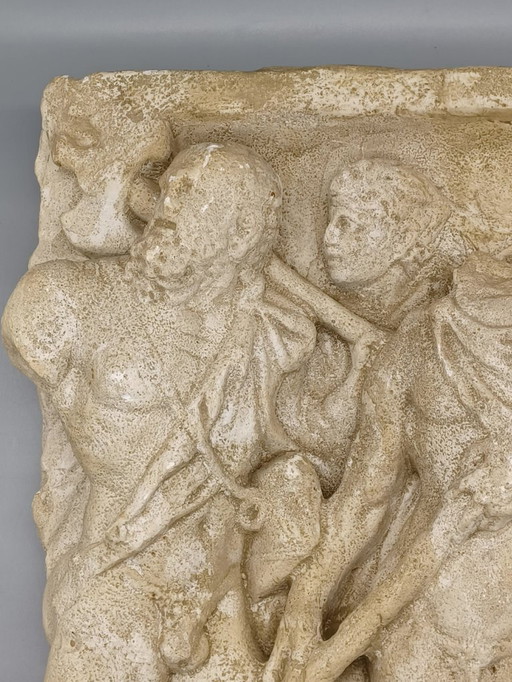 high-relief plaster sculpture depicting an ancient scene