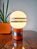 Vintage table lamp with orange wooden base and glass ball shade from the 1960s