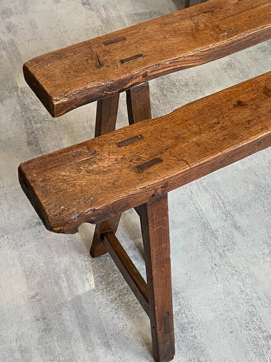 Image 1 of Twee massief eikenhouten boerenbanken van 214 cm voor een rustieke boerentafel uit de jaren 50.