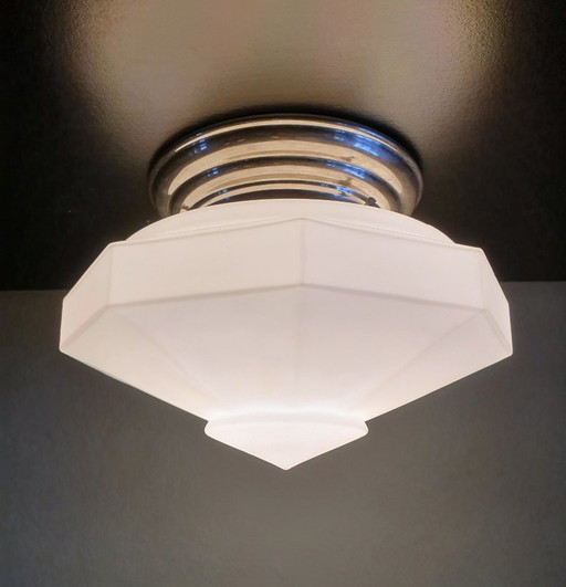 Art Deco ceiling light made of opal glass. Unique shape with a retro design.