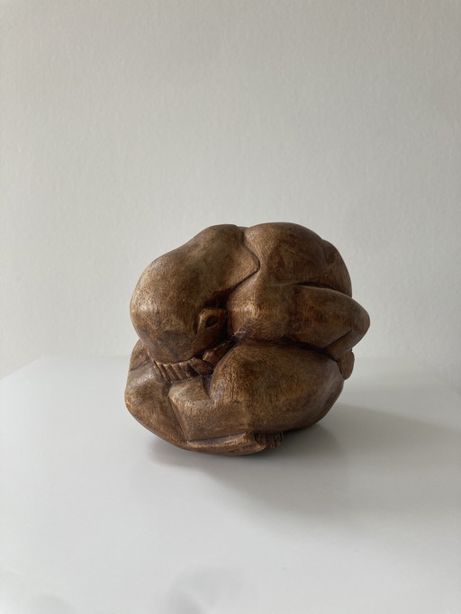 Wood carved figurine of weeping buddha