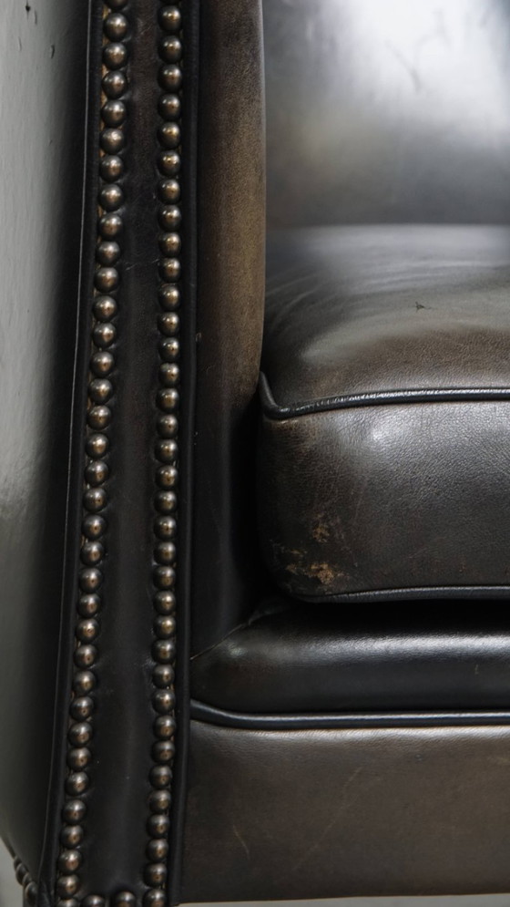 Image 1 of  Set van 2 subtiele zwart/ grijze schapenleren clubfauteuils 