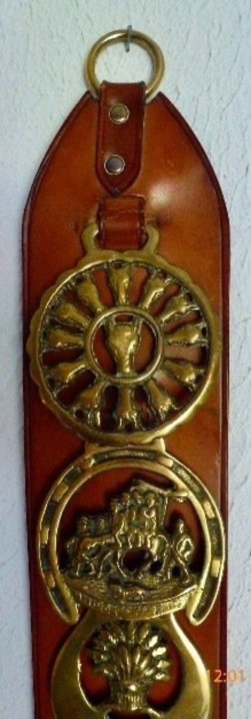 Vintage bell pull with horse-themed copper images.