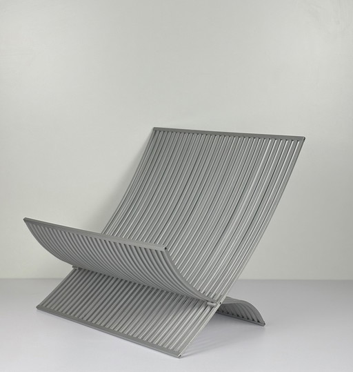 UMBRA book/magazine holder made of brushed aluminum slats. Foldable designer MICHELLE IVANKOVIC