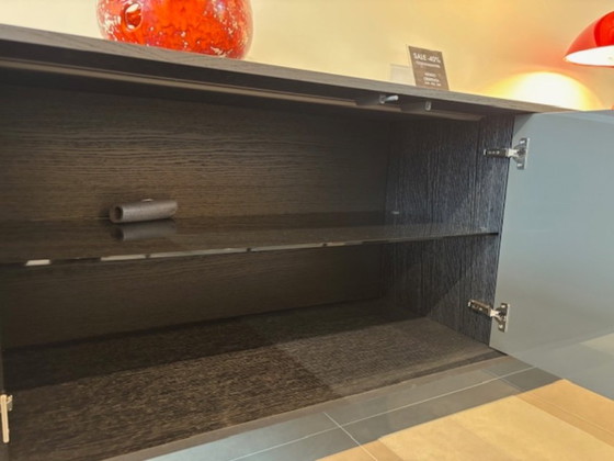 Image 1 of KENDO IS A SIDEBOARD WITH UNUSUAL GEOMETRIC DOORS: EACH ONE HAS A 30° CUT THAT DIVIDES IT INTO TWO PARTS THAT ARE NOT PERFECTLY 