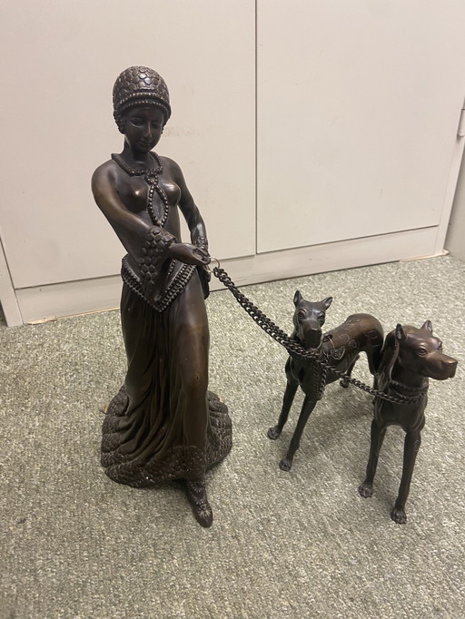 Metal Statue Of Woman With Two Leashed Dogs