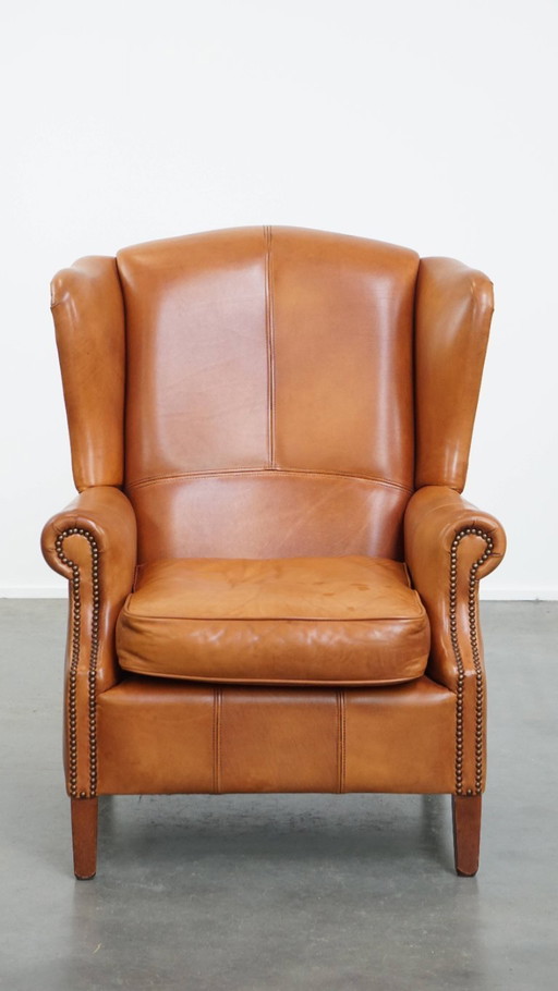 Fauteuil à oreilles en cuir de bœuf avec rivets décoratifs
