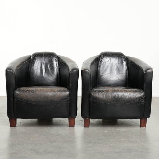 2x rugged black vintage cowhide Aviator design armchairs with a distinctive look