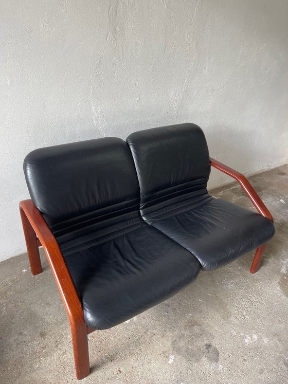 Image 1 of Vintage 2-seater lounge sofa — black leather & solid wood, Italy, 1970s–80s