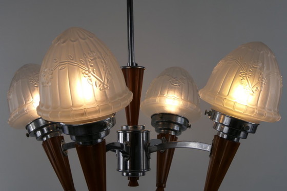 Image 1 of Chrome Art Deco chandelier with four amber Bakelite torches with decorated glass lampshades, ca. 1935
