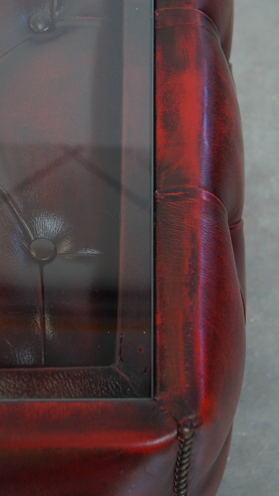 Image 1 of Beef leather chesterfield side/ coffee table in a red color with glass top