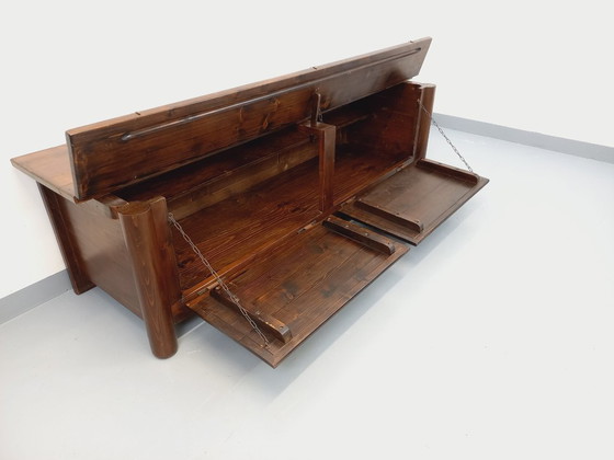 Image 1 of Een laag, brutalistisch dressoir van Georges Robert, gemaakt van donker grenenhout, uit de jaren 50/60.