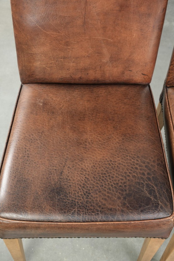 Image 1 of 4 x Vintage eetkamerstoel gemaakt van schapenleer met een hoge rug