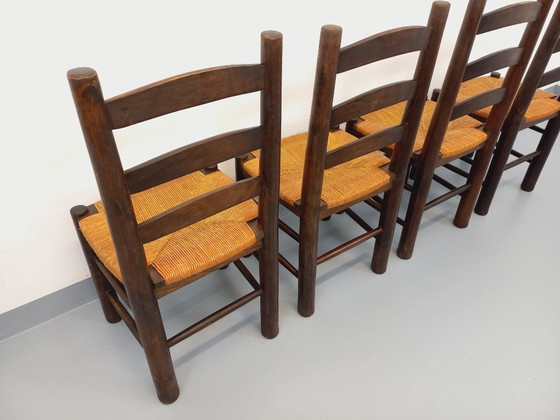 Image 1 of Set van 4 vintage brutalistische stoelen van Georges Robert, gemaakt van hout en stro, uit de jaren 50 en 60.