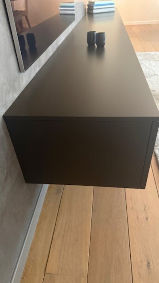 Image 1 of brown wall cupboard (possibly for under TV) with 3 folding doors