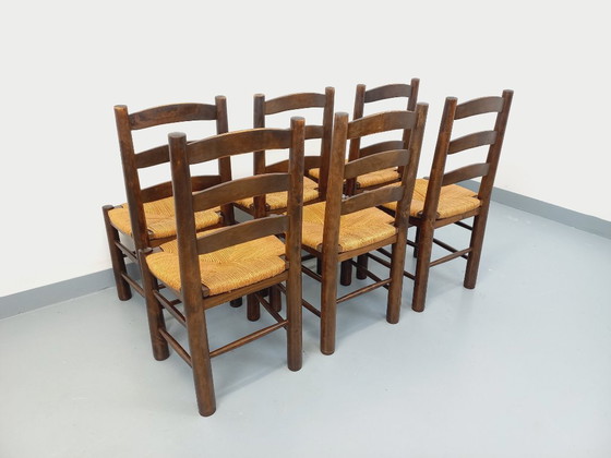 Image 1 of Set van 6 vintage brutalistische stoelen van Georges Robert, gemaakt van hout en stro, uit de jaren 50 en 60.
