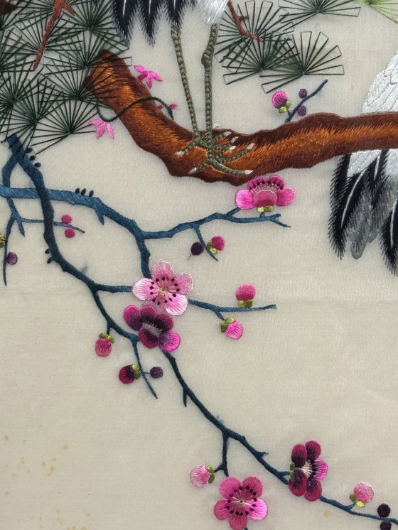 Image 1 of Pannello ricamato giapponese con gru, fiori di ciliegio e sole nascente, XX secolo.