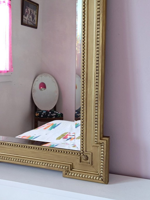 Large antique mirror in gilded wood and beveled glass