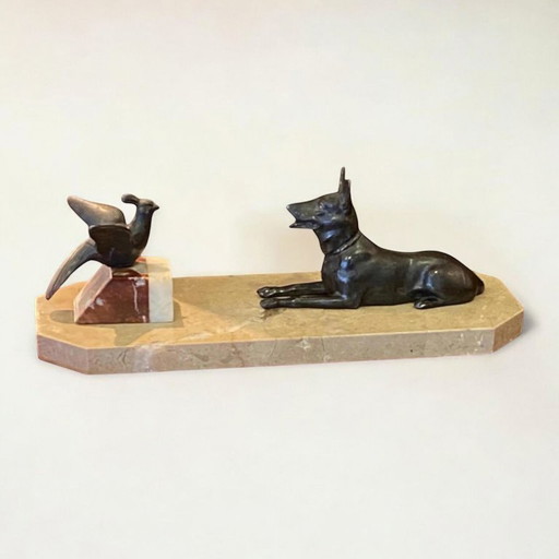 Art Déco bronze sculptures of a shepherd dog and bird on a marble slab. Made in France around 1920.